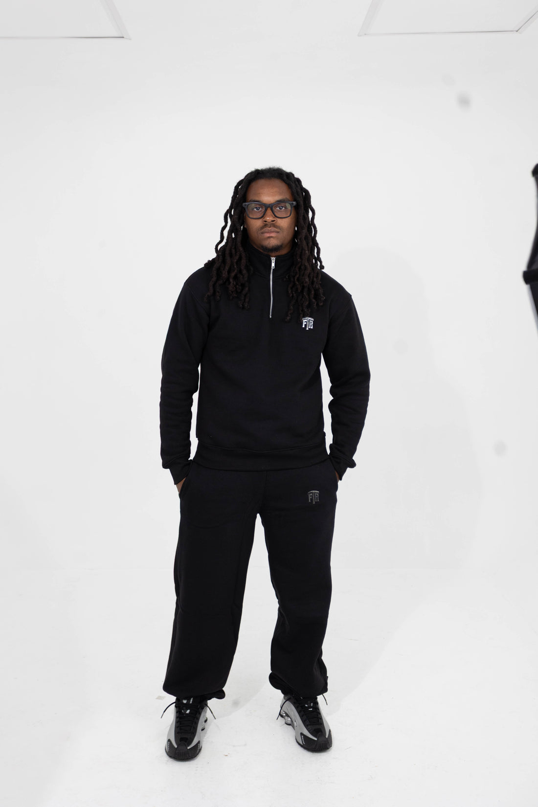 For The Riches black quarter zip and pants set — front campaign view